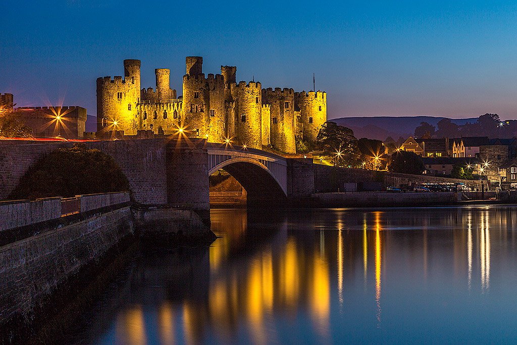 Conwy Castle in North Wales at Night in Lights reflecting in the waters