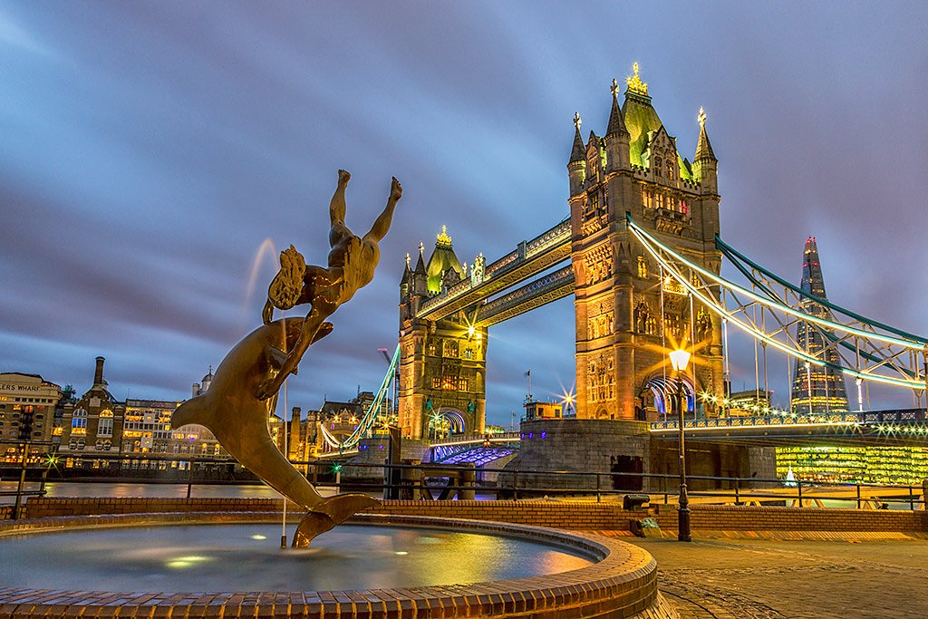 Dolphin and Girl Fountain at Tower Bridge London England at night with the Shard building