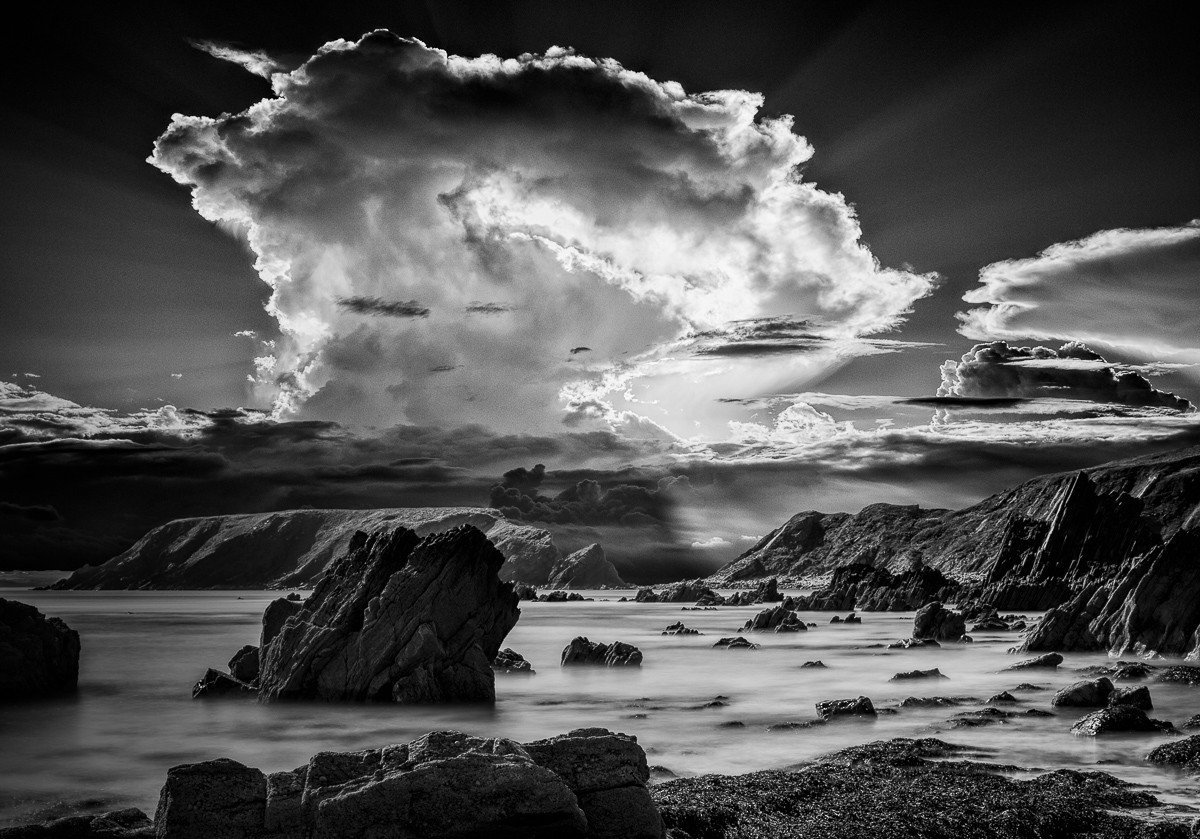 Anglesey Beach and Rocks in Black and White with powerful storm clouds