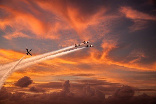 Fighter jet airplanes on sunset red sky